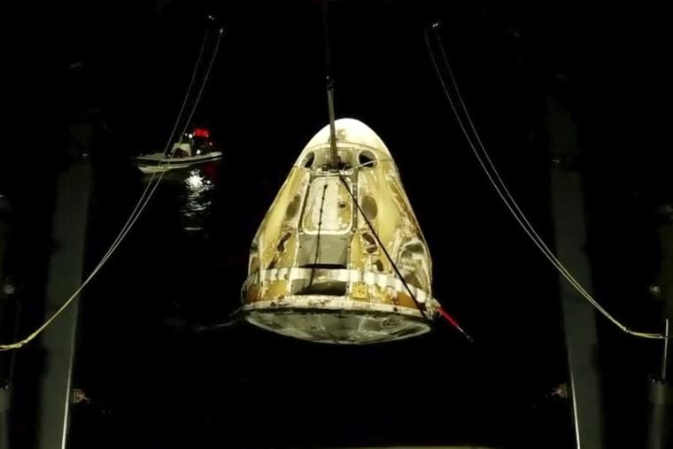 SpaceX Dragon capsule is lifted out of the water after splashing down in the Gulf of Mexico early Friday.