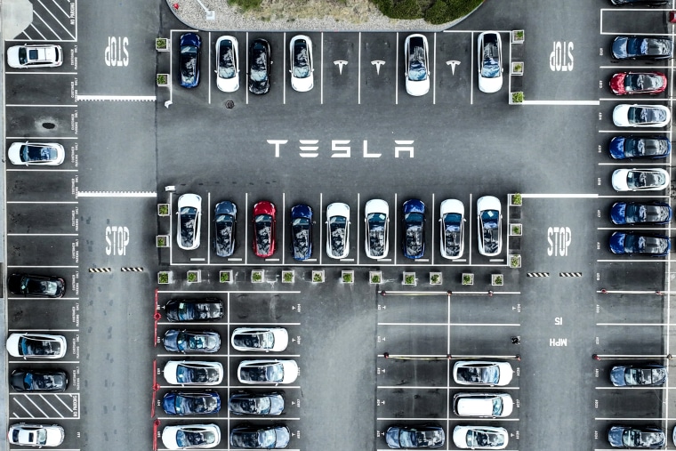 Image: Tesla cars sit parked in a lot at the Tesla factory on April 20, 2022 in Fremont, Calif.