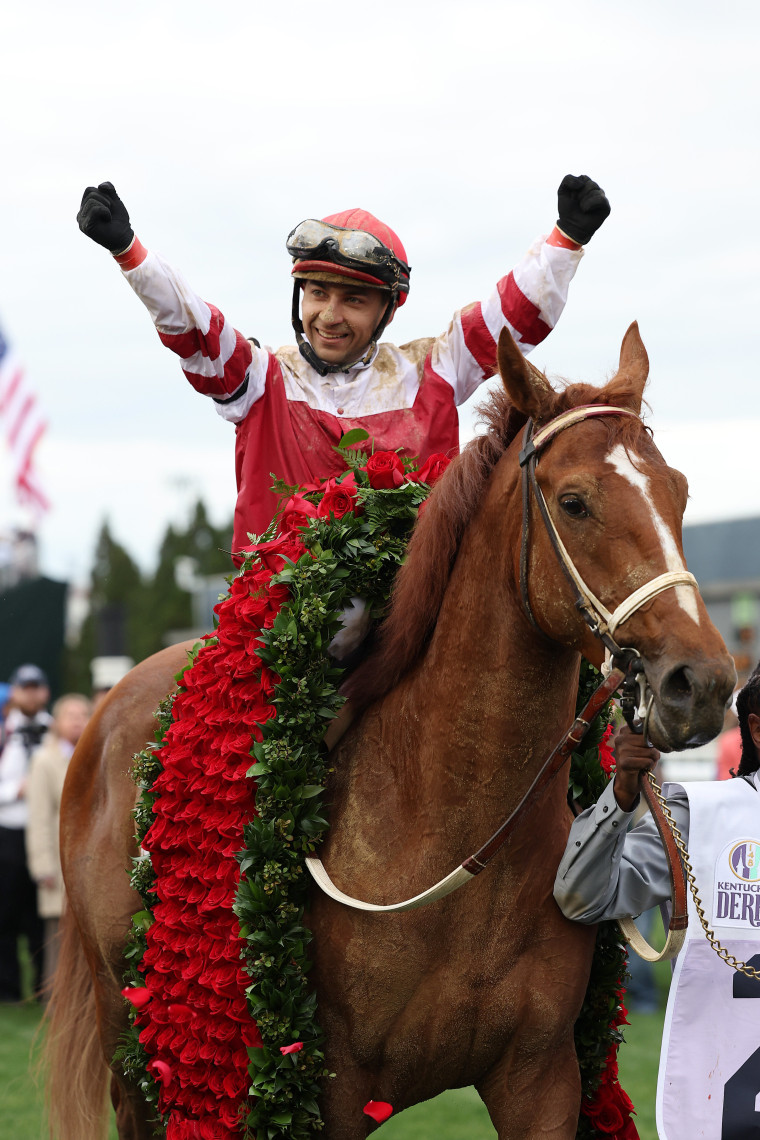 Jockey Sonny Leon celebrates as he rides Rich Strike into the winner's circle after the horse's win during the 148th running of the Kentucky Derby at Churchill Downs on Saturday in Louisville, Kentucky.