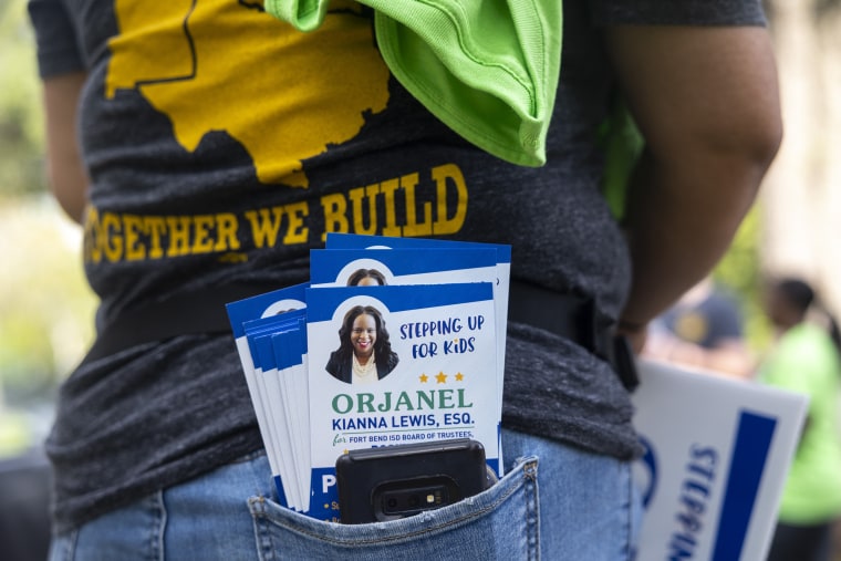 Pamphlets for school board trustee hopeful Orjanel Lewis fill the pocket of IUPAT communications director Jennifer Hernandez on Election Day on May 7, 2022, in Ft. Bend County, Texas.