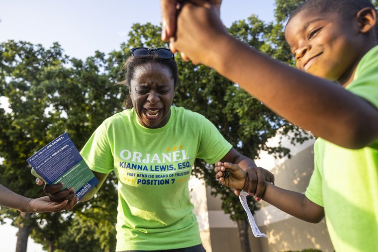 School board trustee hopeful Orjanel Lewis prays with her two children and her mother as the polls close on Election Day on  May 7, 2022, in Ft. Bend County, Texas.