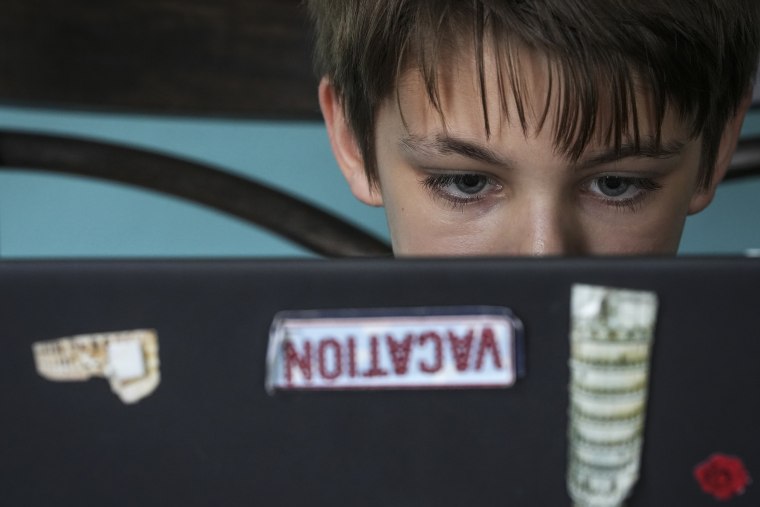 Kim Hough's 12-year-old son, Ethan, browses book selections on the Epic app.