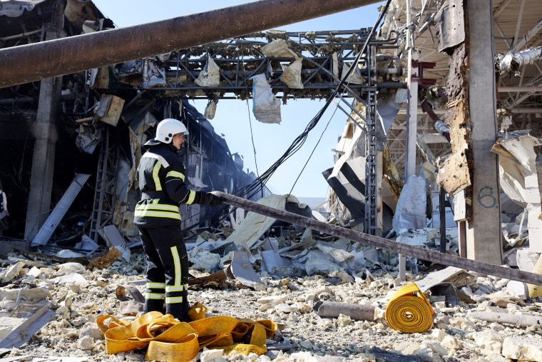 A rescue worker gestures in front of the shopping and entertainment center in the Ukrainian Black Sea city of Odessa on Tuesday, May 10 destroyed after Russian missiles strike late on Monday, May 9.