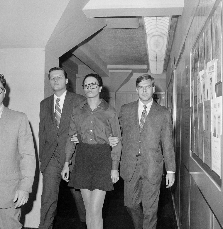 Angela Davis is escorted by two FBI agents