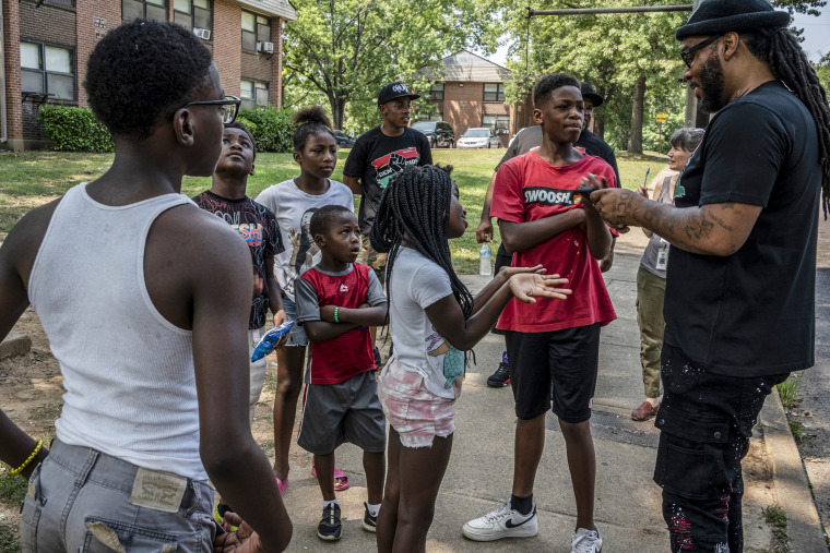 Hambino Godbody talks with kids from the Cumberland View projects where he grew up in Nashville, Tenn., on July 28, 2021.