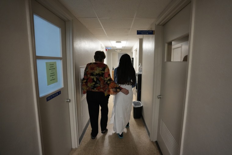 A 33-year-old mother of three from Central Texas is escorted down the hall by a clinic administrator prior to getting an abortion Oct. 9 at Hope Medical Group for Women in Shreveport, La.