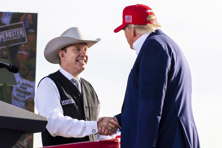 Nebraska Republican gubernatorial candidate Charles Herbster shakes hands with former President Donald Trump during a campaign rally for Herbster on May 1, 2022, in Greenwood.