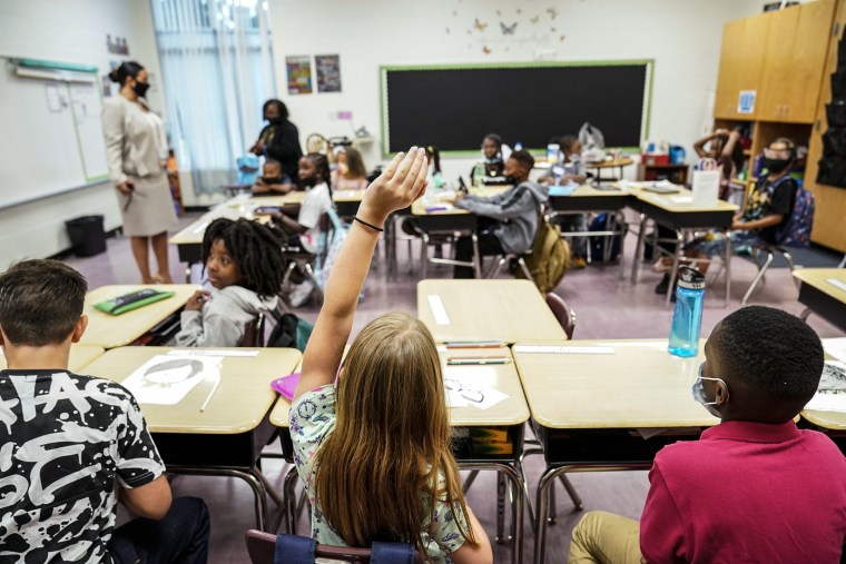 A student raises their hand in a classroom at Tussahaw Elementary school on Aug. 4, 2021, in McDonough, Ga.