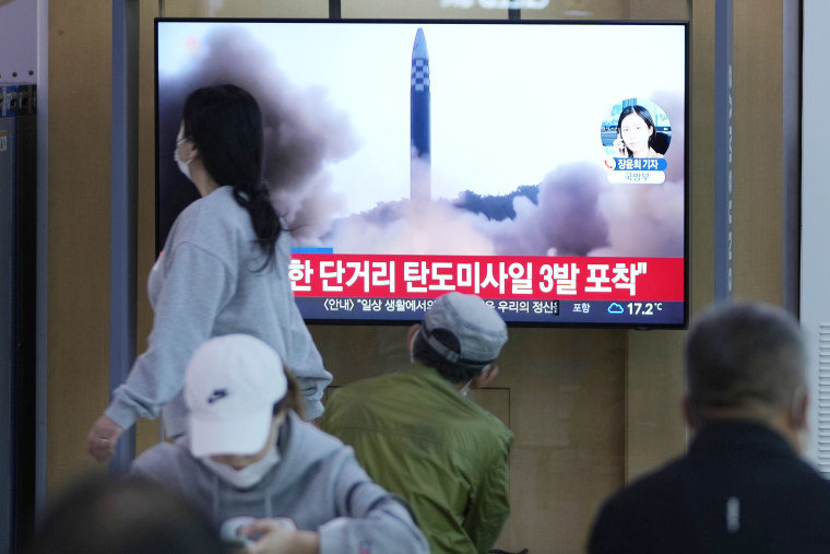 People watch a TV screen showing reporting about North Korea's missile launch at a train station in Seoul, South Korea, on May 12, 2022.