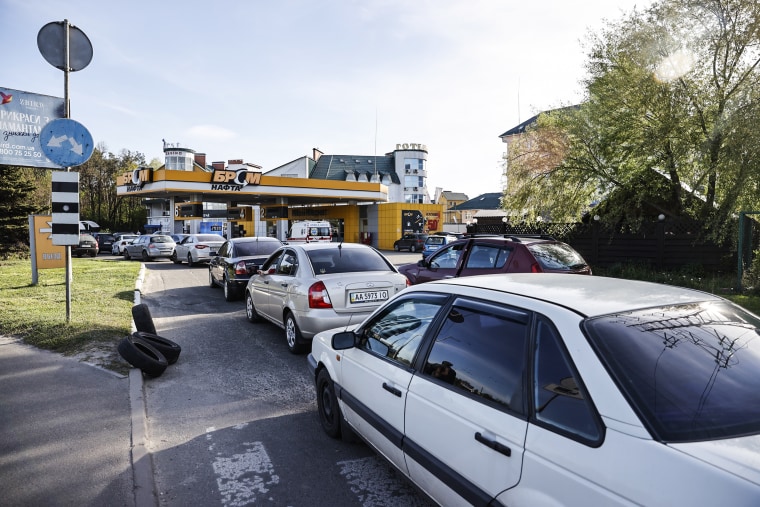 Drivers line up in long queues at a gas station amid the fuel supply cutoff in Kyiv on May 11, 2022.