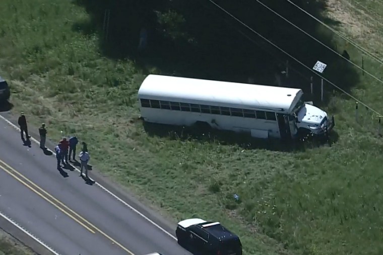 Authorities investigate the area around a prisoner transport bus after an inmate serving a life sentence for murder escaped Thursday in Texas after he stabbed the driver, authorities say.