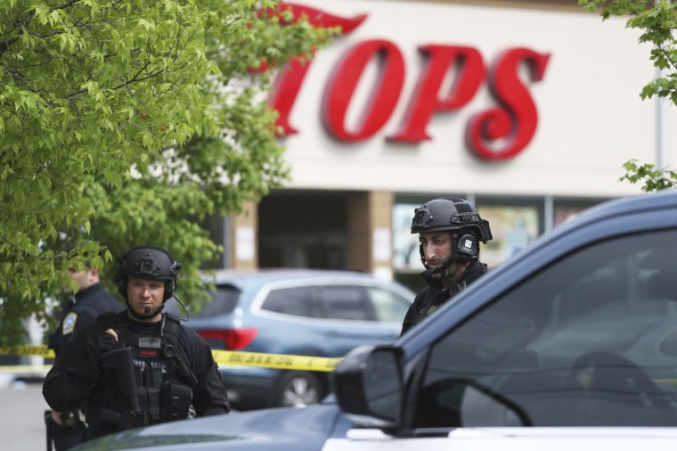 Police secure a perimeter after a shooting at a TOPS Market