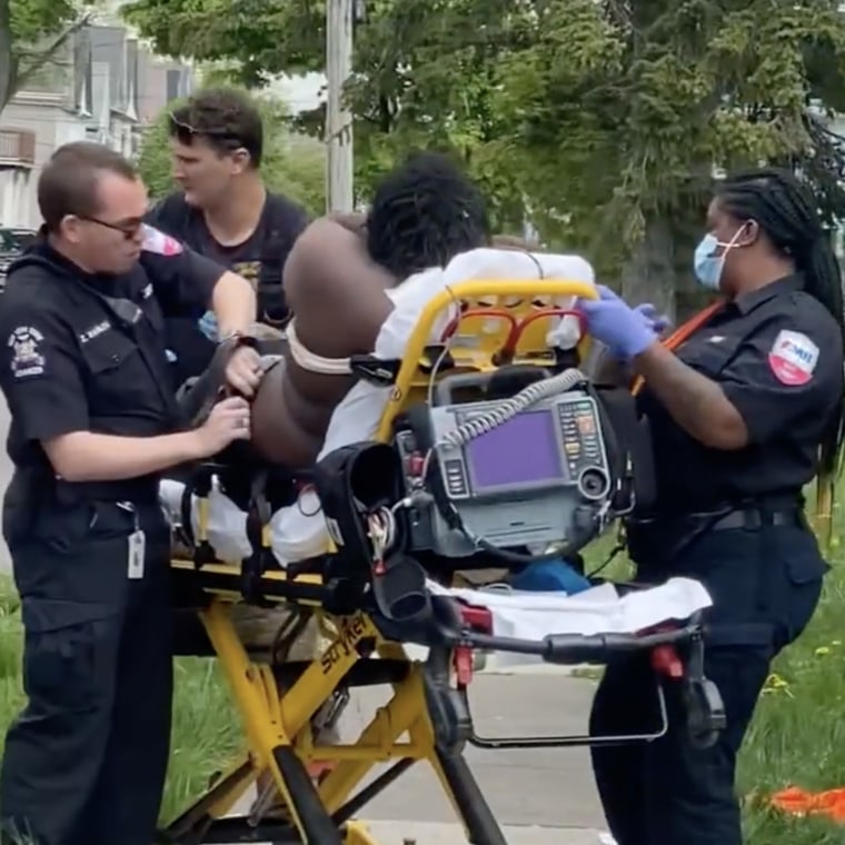 A man sits on a stretcher after a shooting in Buffalo