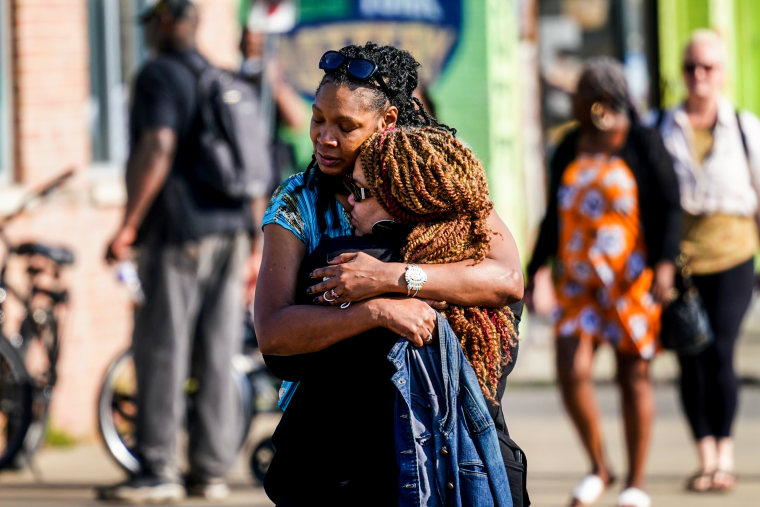 People embrace outside the scene of a shooting at a supermarket in Buffalo, N.Y., on May 15, 2022.