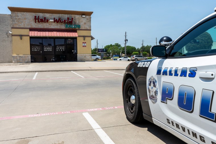 A Dallas police cruiser is stationed outside Hair World Spa on May 14, 2022, where a shooter opened fire and injured three Korean women.