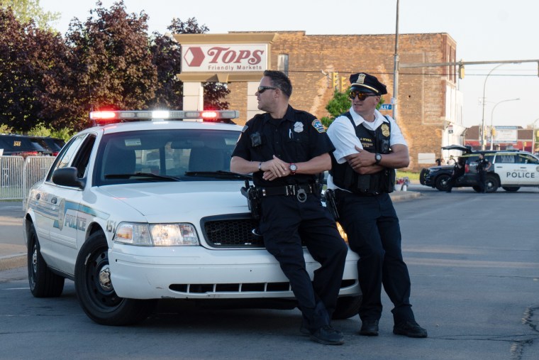 Officers guard the crime scene outside Tops supermarket in Buffalo, N.Y., on Sunday evening. 