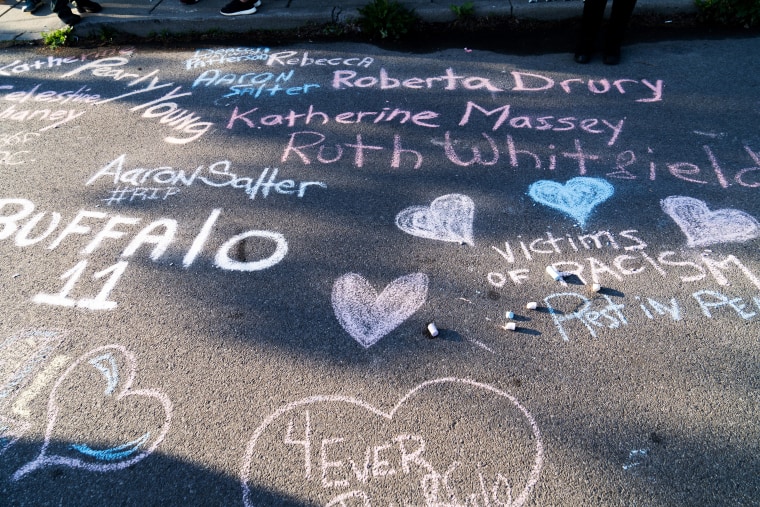 Chalk writings noting the names of victims are inscribed on Landon Street, near the Tops supermarket in Buffalo. 