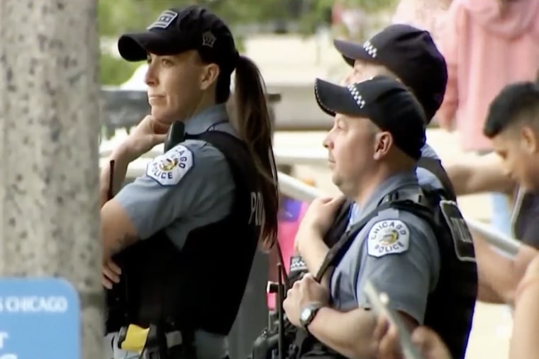 Police officers monitor crowds at 'The Bean' tourist attraction in Millennium Park, Chicago on May 15, 2022.