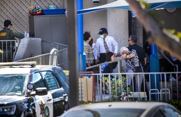 A first responder grief counselor comforts a parishioner after a person opened fire during a church service attended by a Taiwanese congregation, at Geneva Presbyterian Church in Laguna Woods, Calif., on May 15, 2022.