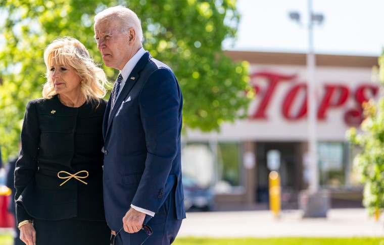 Image: Jill Biden and Joe Biden standing across the street from a supermarket with the sign,"Tops".