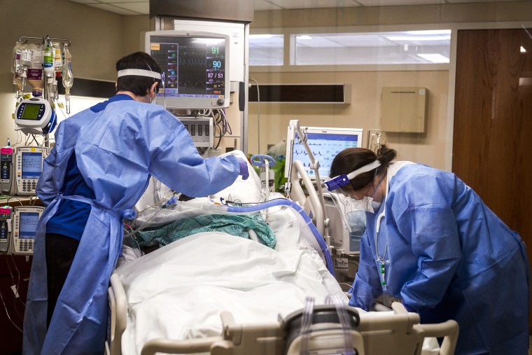 Healthcare workers treat a Covid-19 patient on the Intensive Care Unit floor at Hartford Hospital in Hartford, Conn., on Jan. 31, 2022.