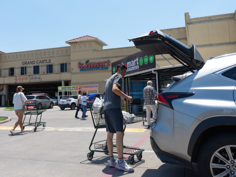 Shoppers outside the Komart Marketplace, which features Korean and other Asian specialties, in Dallas, on May 14, 2022.