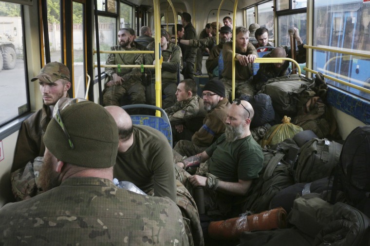 Ukrainian servicemen sit in a bus after they were evacuated from the besieged Azovstal steel plant in Mariupol on Monday.