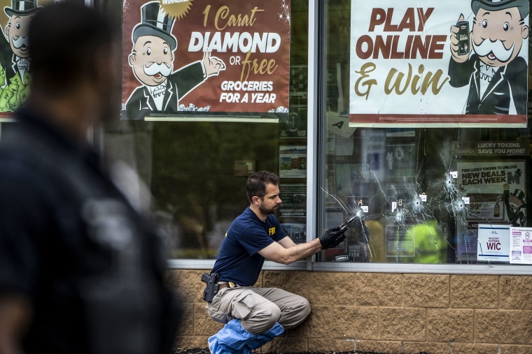 Bullet holes are seen in the window of Tops Friendly Market at Jefferson Avenue and Riley Street, as federal investigators work the scene of a mass shooting on May 16, 2022 in Buffalo, N.Y.