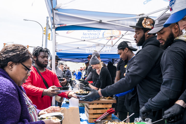Members of the Buffalo Bills help World Central Kitchen distribute meals near the scene of the mass shooting at Tops Friendly Market on May 18, 2022, in Buffalo, N.Y.