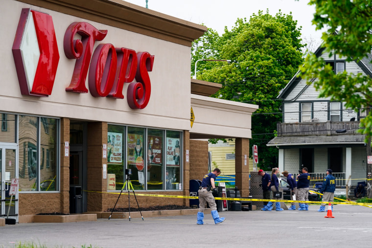 Investigators work at a Tops Friendly Market