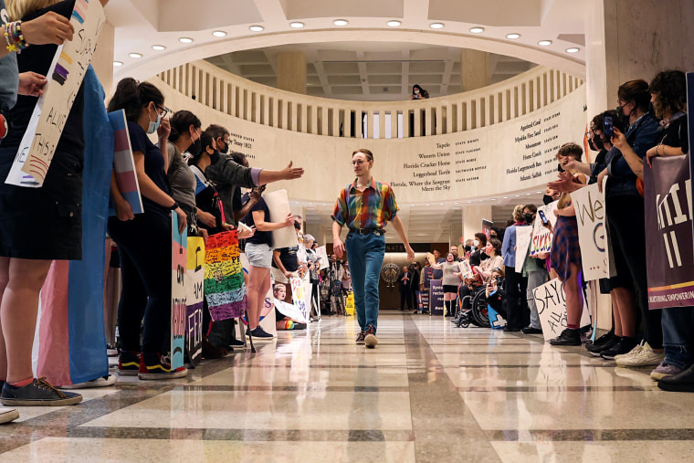 Maxx Fenning, 19, walks among a group of people protesting House Bill 1557, dubbed the "Don't Say Gay" bill by critics, on the fourth floor of the Florida Capitol on March 8, 2022.