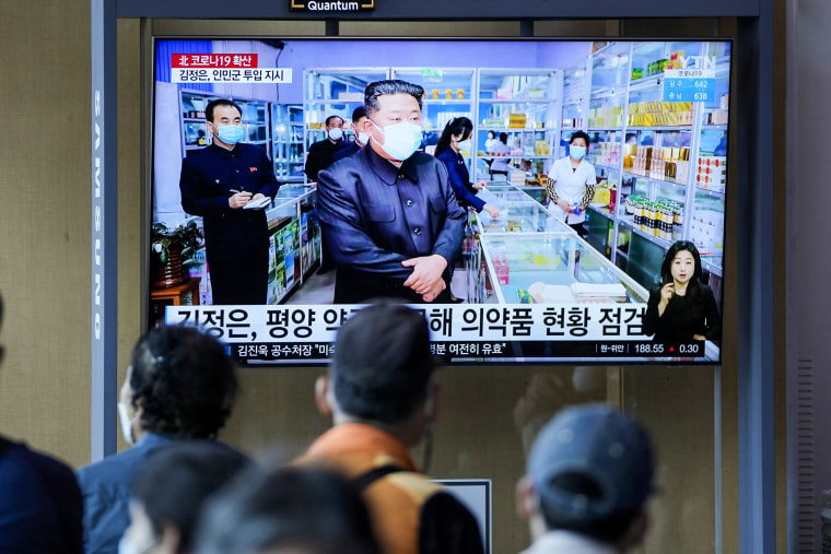 People watch a news broadcast in a train station of North Korean leader Kim Jong Un in Seoul on May 16, 2022.