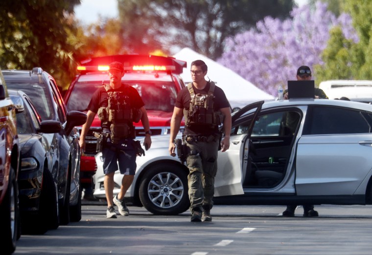 Police investigate the scene of a shooting at the Geneva Presbyterian Church