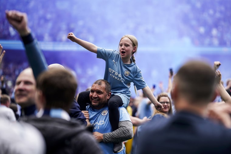 Manchester City fans celebrate after the English Premier League soccer match against Aston Villa at the Etihad Stadium in Manchester, England, on May 22, 2022.