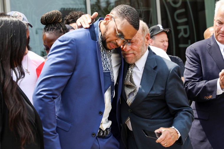 FILE — Grant Williams, left center, is embraced by his attorney Irving Cohen after his murder conviction is vacated on July 22, 2021, in New York.