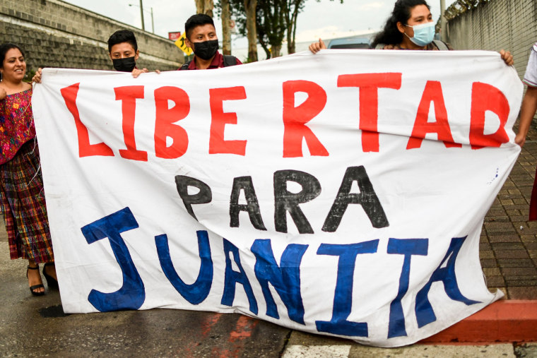 Friends and relatives of Guatemalan migrant Juana Alonzo hold a blanket that reads "Freedom for Juanita" upon her arrival at La Aurora international airport in Guatemala City on May 22, 2022.
