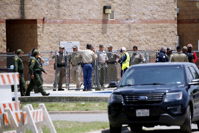 Law enforcement and other first responders gather outside Robb Elementary School following a shooting on Tuesday, May 24 in Uvalde, Texas.
