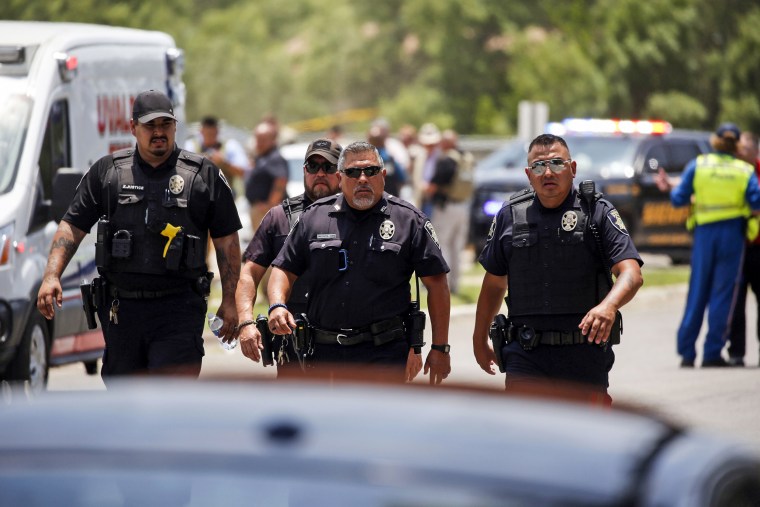 Police walk near Robb Elementary School following a shooting on May 24, 2022, in Uvalde, Texas.