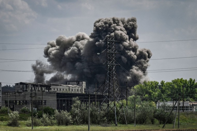 Smoke and dirt ascends after a strike at a factory in the city of Soledar at the eastern Ukranian region of Donbas on May 24, 2022.