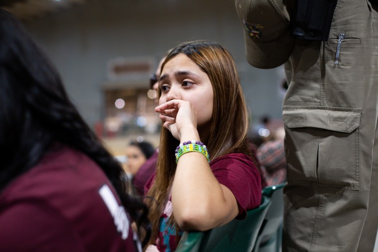 Jen Solis sits with community members during a vigil for the victims of the mass shooting at Robb Elementary School in Uvalde, Texas on May 25, 2022.