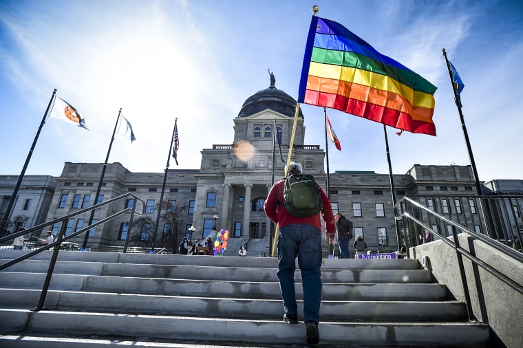 Demonstrators gather on the step of the Montana State Capitol protesting anti-LGBTQ+ legislation on March 15, 2021, in Helena, Mont.