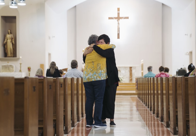 Residents embrace inside a church in Uvalde, Texas, on Wednesday.