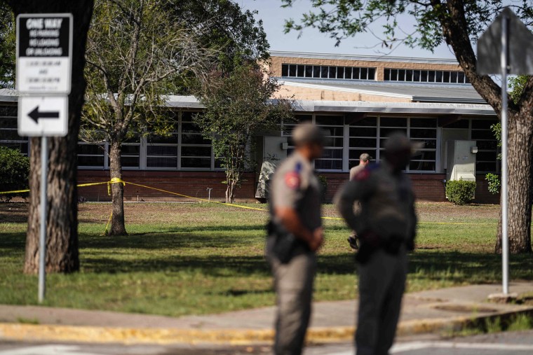 Image: Officers stand outside Robb Elementary School in Uvalde, Texas, on May 25, 2022.