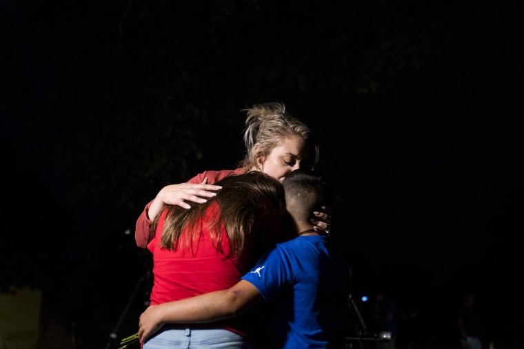 A woman embraces two children outside Willie de Leon Civic Center in Uvalde, Texas, on May 24, 2022.