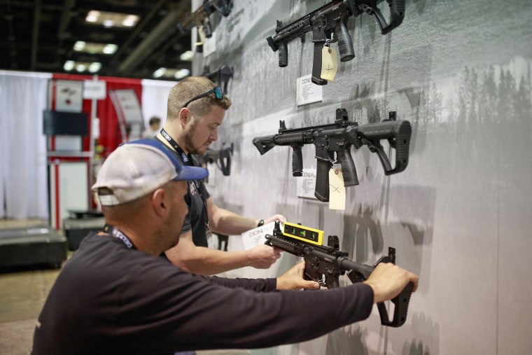Workers prepare the Daniel Defense booth before the National Rifle Association convention in Indianapolis in 2019.