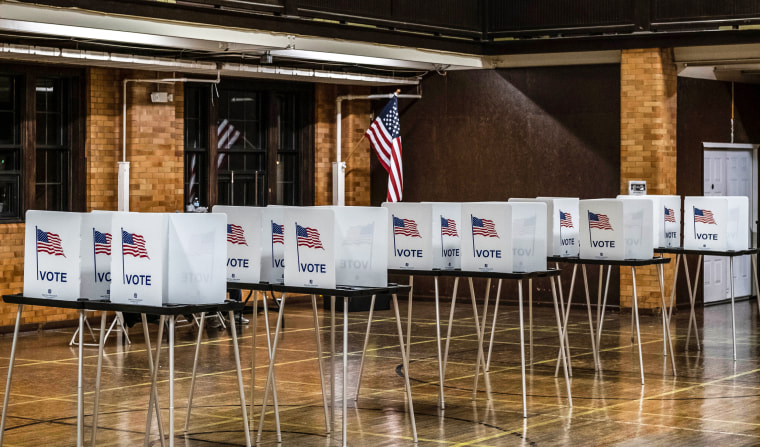 Empty voting booths are seen in Flint, Mich., at the Berston Fieldhouse polling place on Nov. 3, 2020.