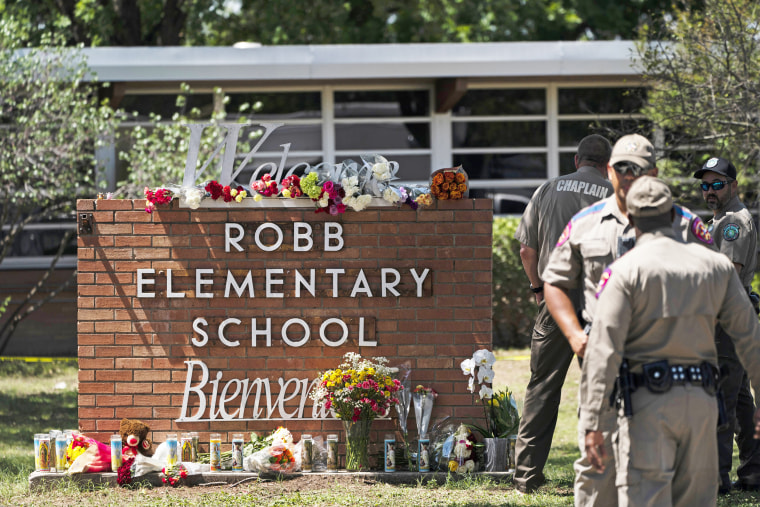 Flowers and candles are placed outside Robb Elementary School