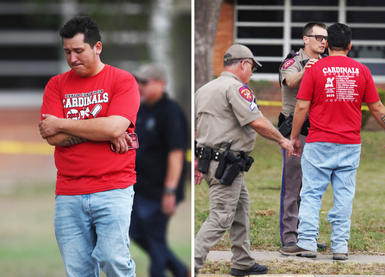 A distraught man paces at Robb Elementary School
