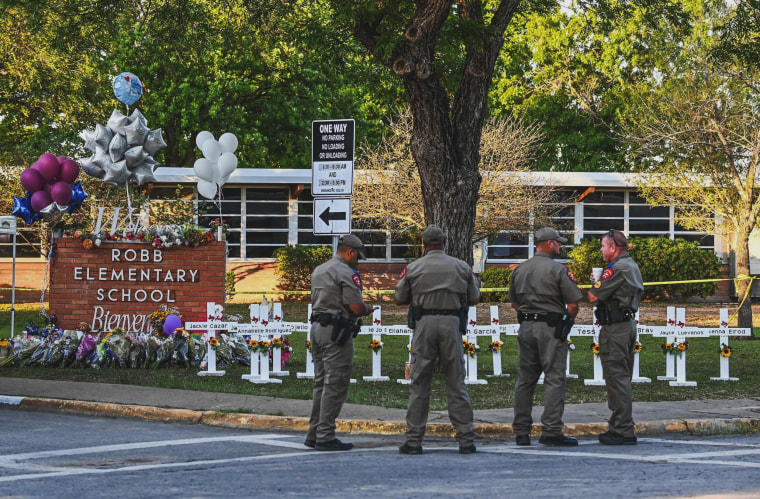 Image: Police officers outside of the Robb Elementary School after 19 students and two teachers were killed in a mass shooting in Uvalde, Texas, on May 26, 2022.