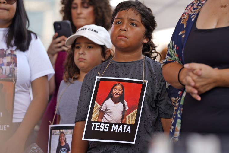 A young protester wears an image of Tess Mata, who was killed in the Uvalde school shooting, outside the NRA meeting. 